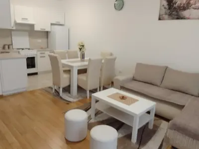 a living room with a couch and a table at Happy Day in Obrenovac