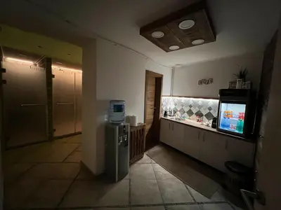a kitchen with a refrigerator and a television in it at Wolf Spa Apartment in Belgrade