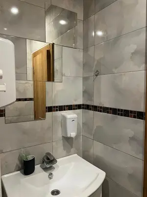 a bathroom with a white sink and a mirror at Wolf Spa Apartment in Belgrade