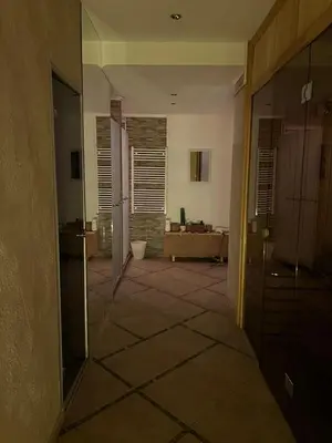 an empty hallway with a room with a couch at Wolf Spa Apartment in Belgrade