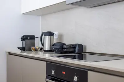 a kitchen with a coffee maker on a counter at Terra Luxe Residences in Sajmište