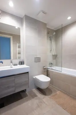 a bathroom with a toilet and a sink and a tub at Terra Luxe Residences in Sajmište