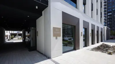 a building with a sign on the side of it at Terra Luxe Residences in Sajmište
