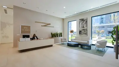 a lobby of a building with a woman sitting at a desk at Terra Luxe Residences in Sajmište
