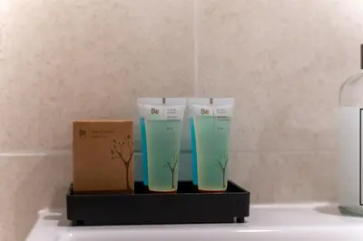 two plastic vases sitting on a shelf next to a lamp at ZIGZAG Belgrade Waterfront Terra in Belgrade