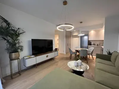 a living room with a couch and a table at ZIGZAG Belgrade Waterfront Terra in Belgrade