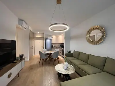 a living room with a couch and a table at ZIGZAG Belgrade Waterfront Terra in Belgrade