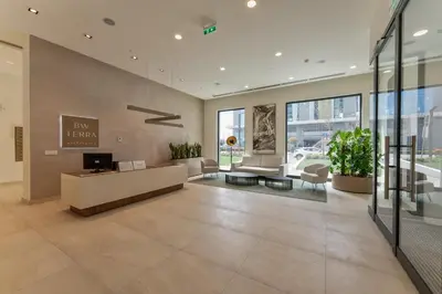 an office lobby with a reception desk and chairs at ZIGZAG Belgrade Waterfront Terra in Belgrade