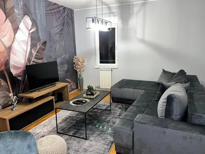 a living room with a couch and a tv at Fairy tale apartment in Dušanovac (historical)