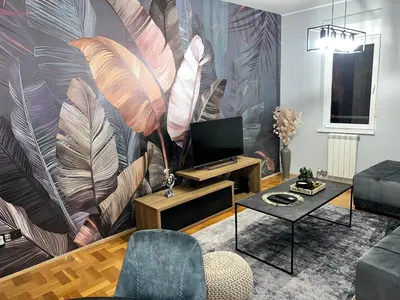 a living room with a large mural of feathers at Fairy tale apartment in Dušanovac (historical)