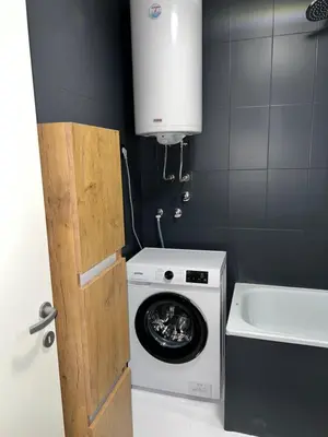 a washer and dryer in a small bathroom at Fairy tale apartment in Dušanovac (historical)