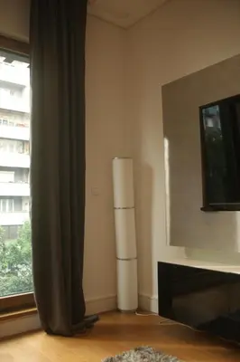 a living room with a window and a lamp at Natalie's Condo in Belgrade