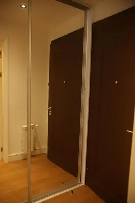 a large mirror in a room with a door at Natalie's Condo in Belgrade