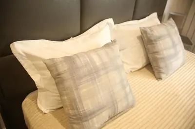 two pillows sitting on top of a bed at Natalie's Condo in Belgrade