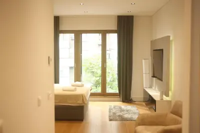 a hotel room with a bed and a window at Natalie's Condo in Belgrade