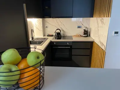 a kitchen with a bowl of fruit on a counter at LL65 Apartments Vracar in Belgrade