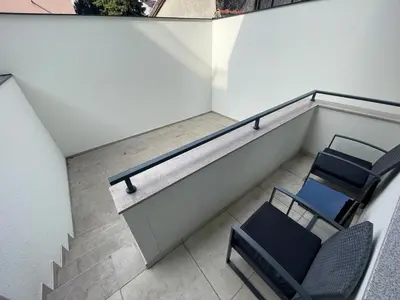 an overhead view of a balcony with chairs and stairs at LL65 Apartments Vracar in Belgrade