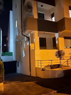 a yellow and white building with a tree in front of it at LL65 Apartments Vracar in Belgrade