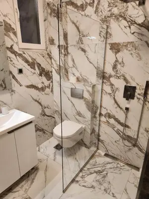 a bathroom with a toilet and a glass shower at LL65 Apartments Vracar in Belgrade