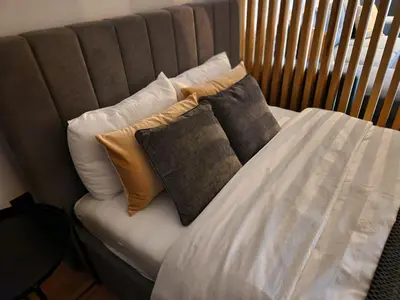 a bed with two pillows on top of it at LL65 Apartments Vracar in Belgrade