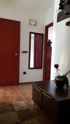 a living room with a table and a mirror at NeraBella Apartment in Belgrade