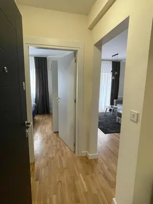 an open door to a room with a living room at Cvetanov trg LUX 1 in Belgrade
