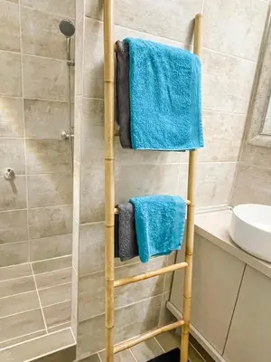 a towel rack in a bathroom with blue towels at Skadarlija ColorWay in Belgrade