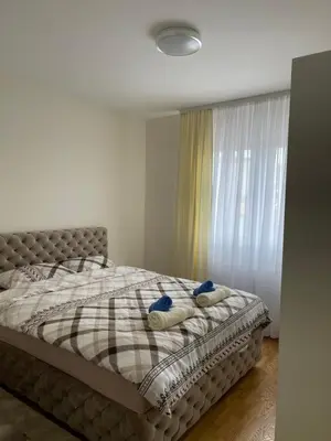 a bedroom with a bed with two pillows on it at Cvetanov trg LUX 2 in Belgrade