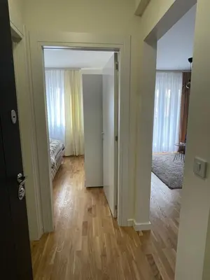 an empty room with a bedroom and a hallway with a door at Cvetanov trg LUX 2 in Belgrade