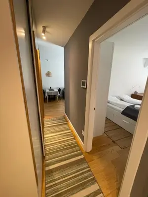 a hallway leading to a bedroom with a bed at Happy Corner New Belgrade in Novi Beograd