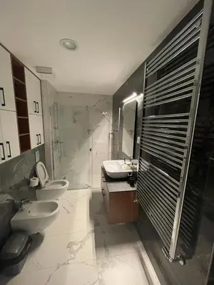 a bathroom with two toilets and a sink and a shower at Happy Corner New Belgrade in Novi Beograd