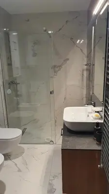 a bathroom with a shower and a sink and a toilet at Happy Corner New Belgrade in Novi Beograd