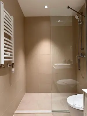 a bathroom with a shower and a toilet and a sink at Apartman Grand BW in Belgrade