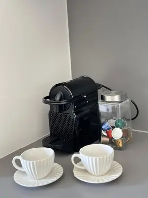 a coffee maker and two cups on a counter at Apartman Grand BW in Belgrade