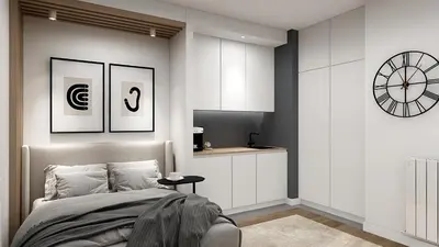 a bedroom with a bed and a clock on the wall at Apartman Grand BW in Belgrade