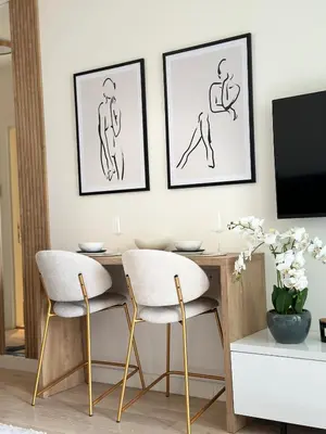 a dining room table with two chairs and a tv at Apartman Grand BW in Belgrade