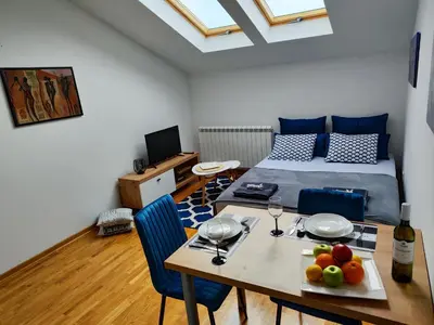 a bedroom with a table with a bed and a table with fruit on it at Zvezdara blue star in Zvezdara