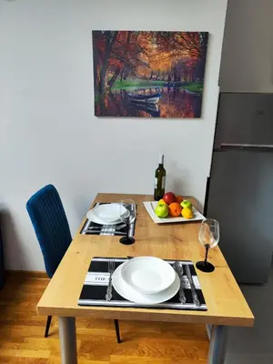 a wooden table with two white plates on it at Zvezdara blue star in Zvezdara