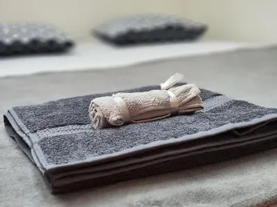 a pile of towels sitting on top of a bed at Zvezdara blue star in Zvezdara