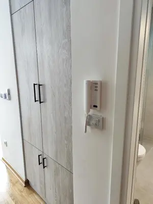 a bathroom with a door with a phone on it at Zvezdara blue star in Zvezdara