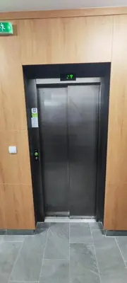 a couple of metal doors in a building at Zvezdara blue star in Zvezdara