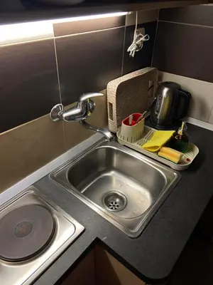 a kitchen counter with a sink in a kitchen at Mala Bella in Zemun