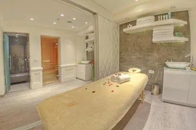 a bathroom with a large bed and a sink at Hotel Moskva in Belgrade