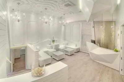a white bathroom with white furniture and chandeliers at Hotel Moskva in Belgrade