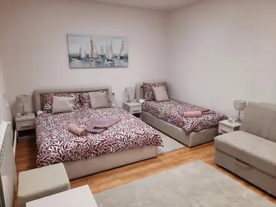 a living room with two beds and a couch at Aleksa 1 in Belgrade