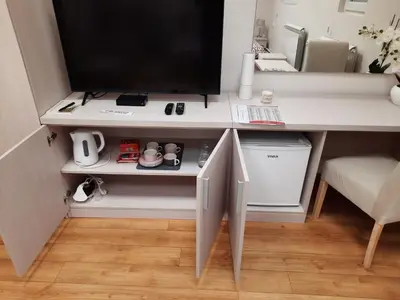 a computer desk with a television on top of it at Aleksa 1 in Belgrade
