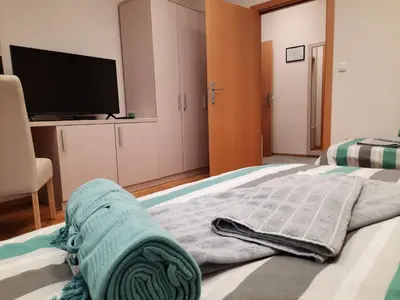 a bedroom with a bed with a flat screen tv at Aleksa 2 in Belgrade
