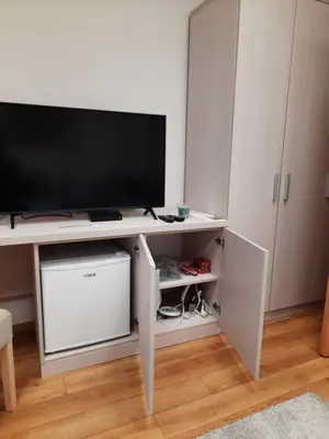 a living room with a television on a white desk at Aleksa 2 in Belgrade