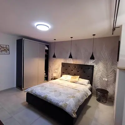 a bedroom with a large bed with lights on it at Jelena in Vračar (historical)