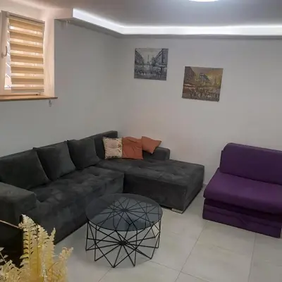 a living room with a couch and a table at Jelena in Vračar (historical)